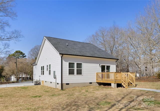 rear view of property with central AC unit, a yard, and a deck