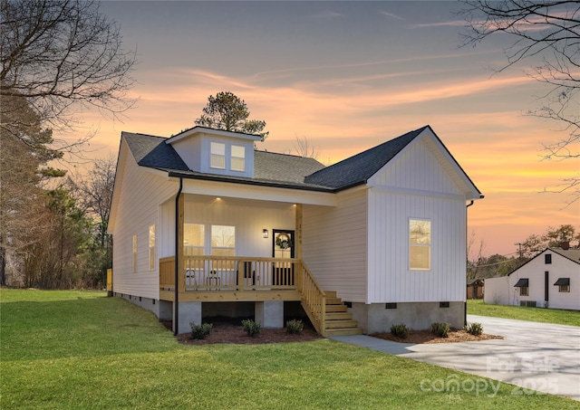 view of front facade with a lawn and covered porch