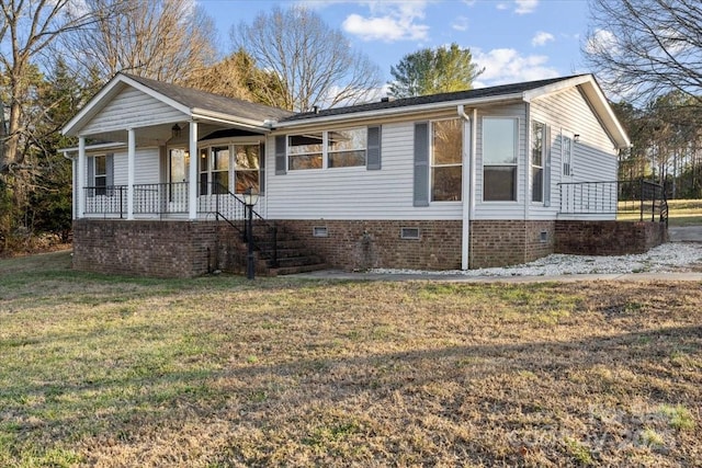 ranch-style house with a porch and a front yard