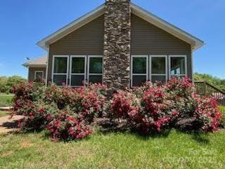 660 Scoggins Rd, Rutherfordton, NC 28139 - view of side of property featuring a lawn and a chimney