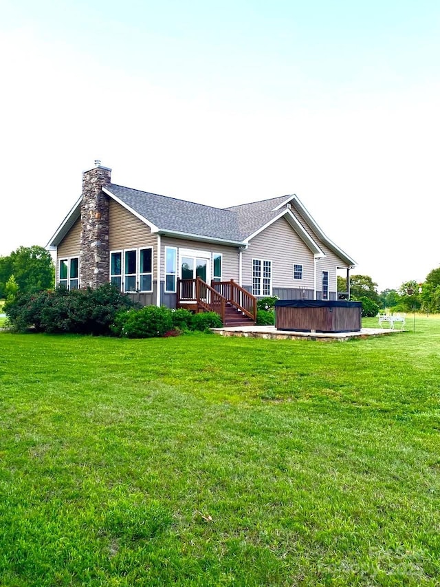 660 Scoggins Rd, Rutherfordton, NC 28139 - rear view of house with a chimney, a wooden deck, and a lawn