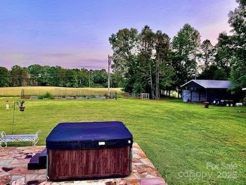 660 Scoggins Rd, Rutherfordton, NC 28139 - yard at dusk with a hot tub, a yard, and view of scattered trees