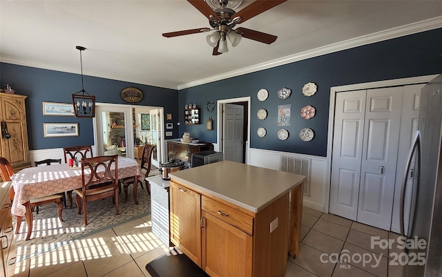 660 Scoggins Rd, Rutherfordton, NC 28139 - kitchen featuring light tile patterned floors, ornamental molding, wainscoting, a ceiling fan, and a chandelier