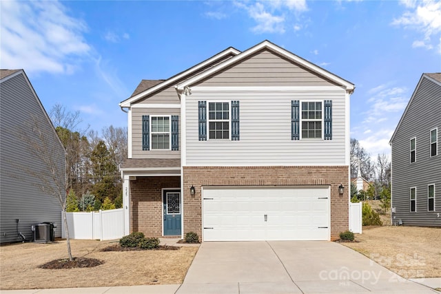 traditional home with driveway, a garage, fence, central AC, and brick siding