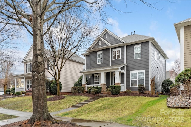 craftsman inspired home with a front yard and a porch