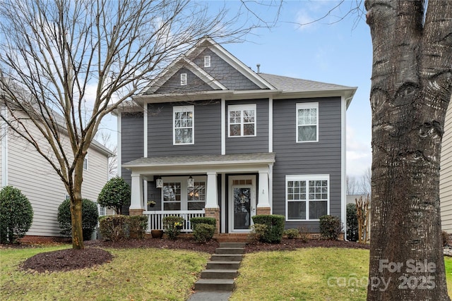 view of front of home with a front lawn and a porch