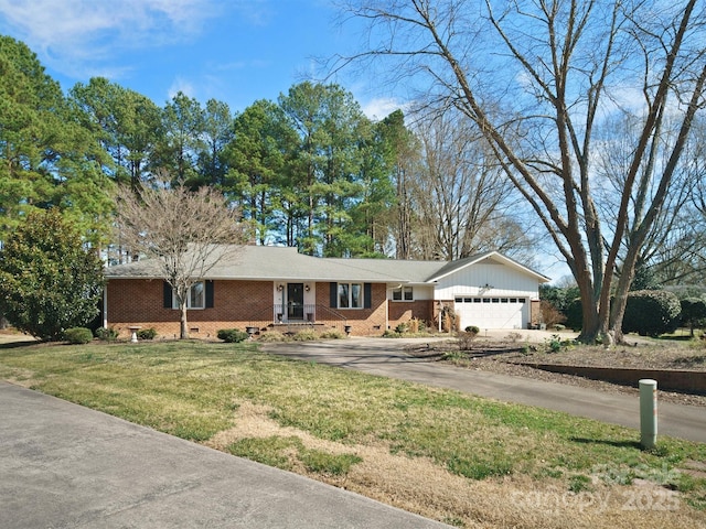 ranch-style home featuring a garage and a front lawn