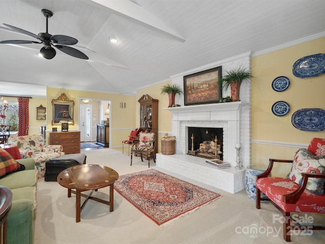 carpeted living room featuring lofted ceiling, a fireplace, ornamental molding, and ceiling fan