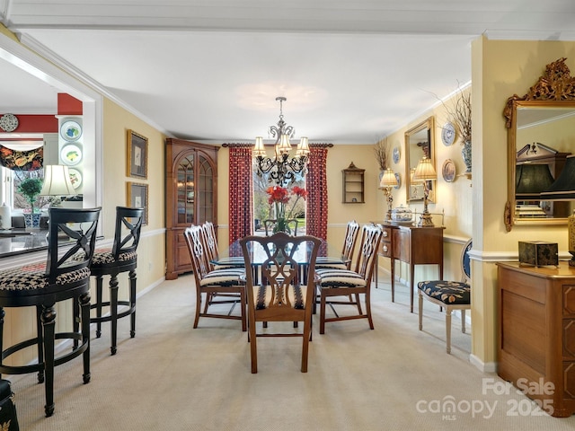 carpeted dining room featuring ornamental molding and a notable chandelier