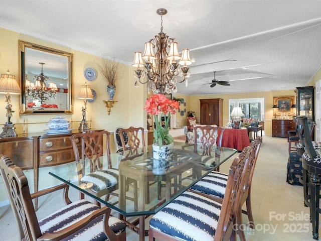 dining room featuring ceiling fan with notable chandelier and light carpet