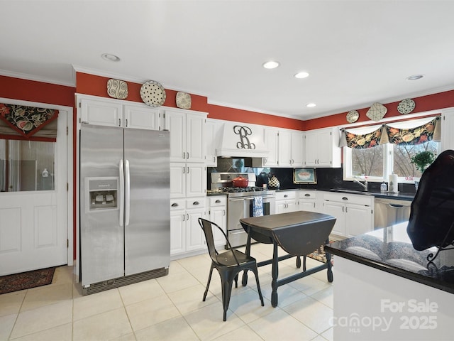 kitchen featuring sink, white cabinets, backsplash, ornamental molding, and stainless steel appliances