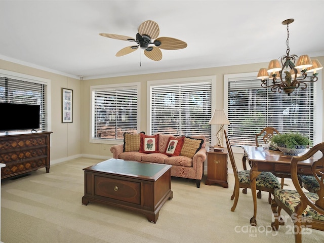 living room with light carpet, ceiling fan with notable chandelier, and ornamental molding