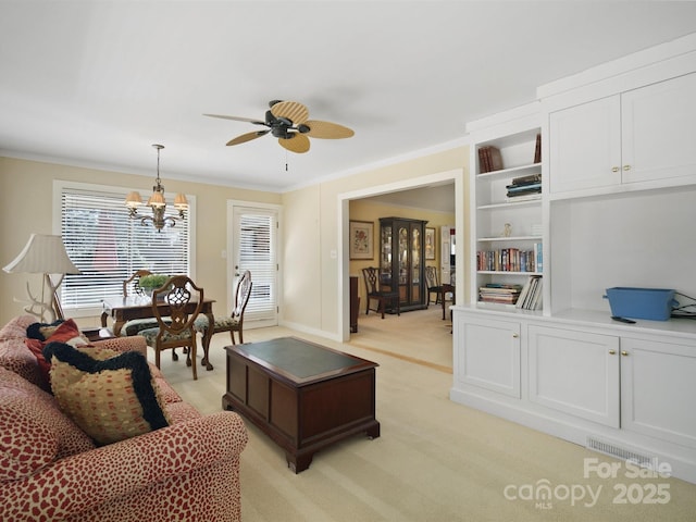 living room featuring light carpet, ceiling fan with notable chandelier, and ornamental molding