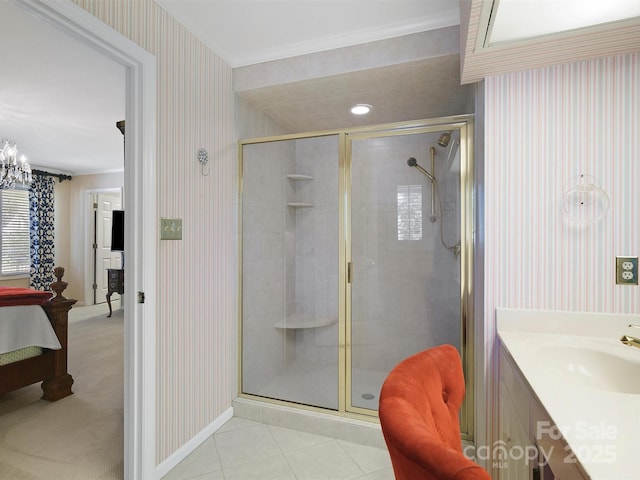 bathroom featuring vanity, ornamental molding, a shower with shower door, tile patterned floors, and a chandelier