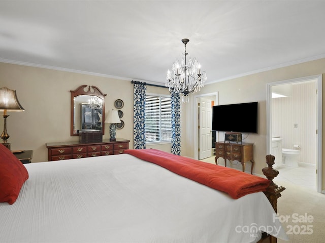 carpeted bedroom featuring ornamental molding, ensuite bathroom, and an inviting chandelier