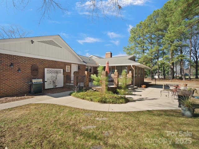 exterior space with a patio area and a lawn