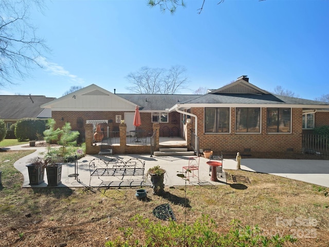 rear view of house featuring a yard and a patio area