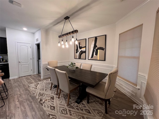 dining area with ornamental molding and hardwood / wood-style floors