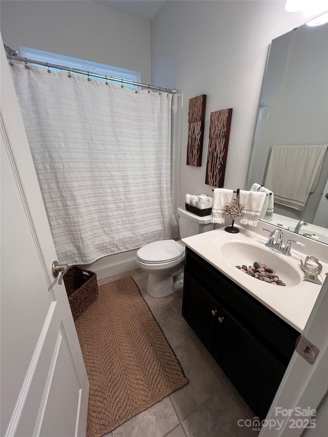 full bathroom with vanity, tile patterned floors, shower / bath combo with shower curtain, and toilet