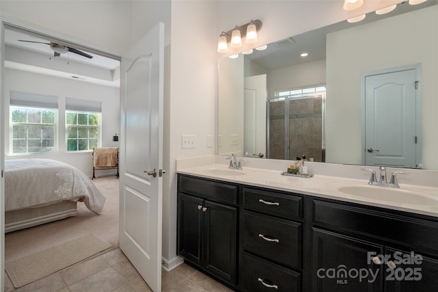 bathroom featuring tile patterned floors, vanity, and a shower with door