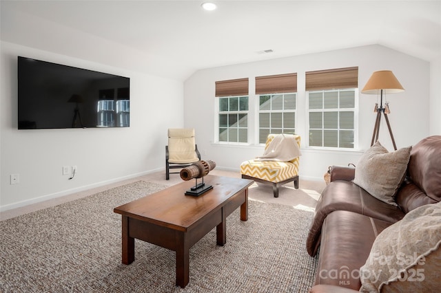 carpeted living room with vaulted ceiling