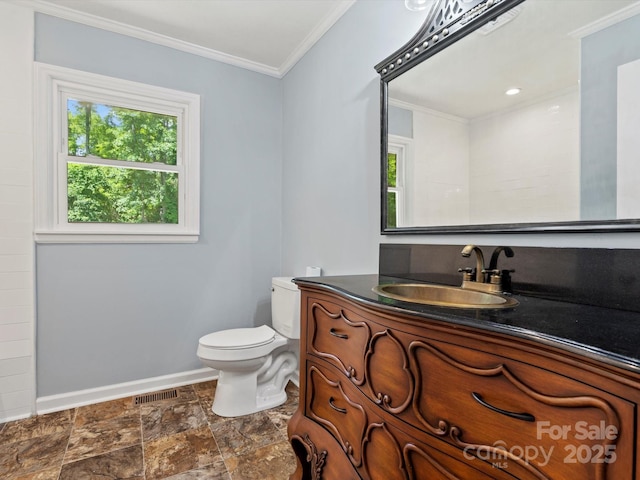 bathroom with ornamental molding, toilet, and vanity