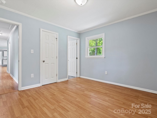 unfurnished bedroom featuring ornamental molding and light wood-type flooring