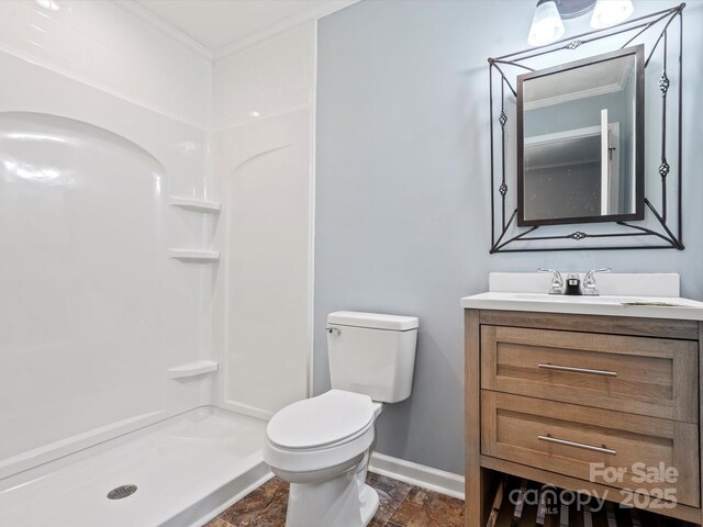 bathroom featuring crown molding, vanity, toilet, and walk in shower