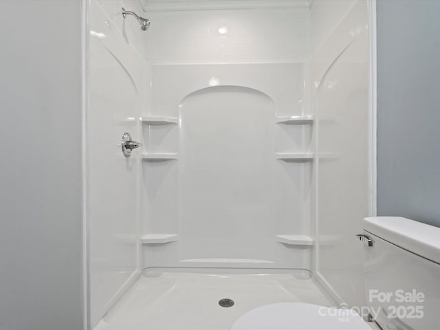 bathroom with toilet and walk in shower