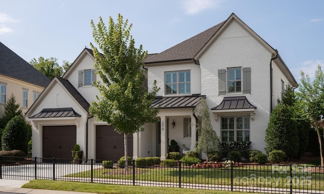 view of front of home featuring a garage and a front yard