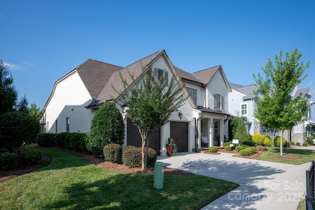 view of front of home featuring a garage and a front yard