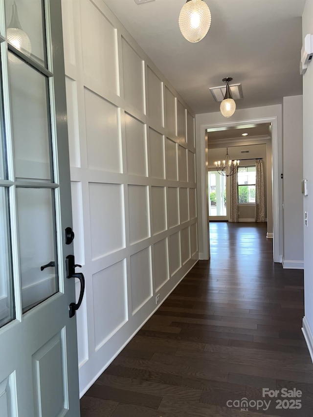 hallway featuring a notable chandelier and dark hardwood / wood-style floors