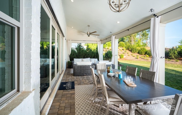 sunroom with lofted ceiling, a wealth of natural light, and ceiling fan