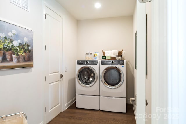 laundry room featuring dark hardwood / wood-style flooring and washing machine and dryer