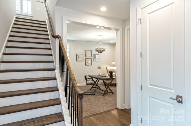 stairs featuring hardwood / wood-style floors