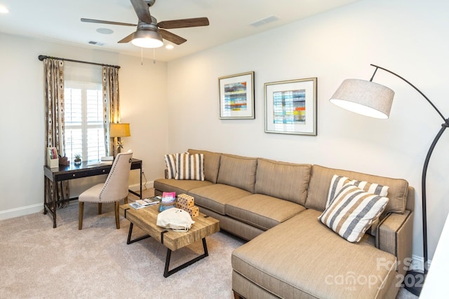 living room featuring light colored carpet and ceiling fan