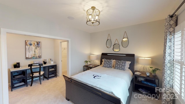 bedroom with carpet flooring and an inviting chandelier