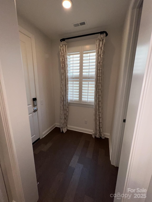 unfurnished room featuring dark hardwood / wood-style flooring