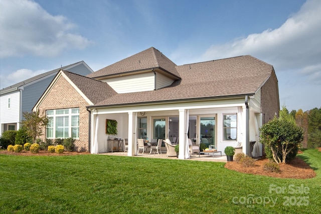 rear view of house featuring a lawn and a patio