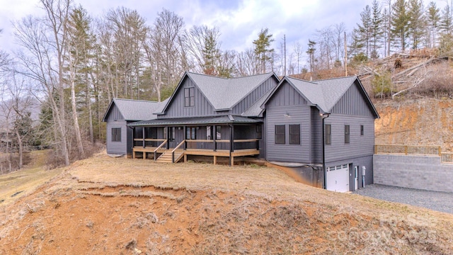 view of front of home featuring a garage and a sunroom