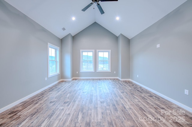 unfurnished room featuring high vaulted ceiling, ceiling fan, and light wood-type flooring