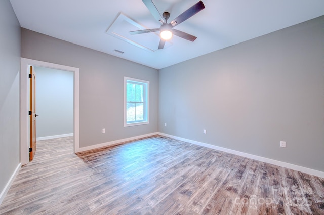 empty room with light hardwood / wood-style floors and ceiling fan