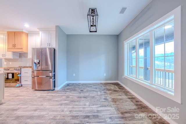 dining space with light hardwood / wood-style flooring