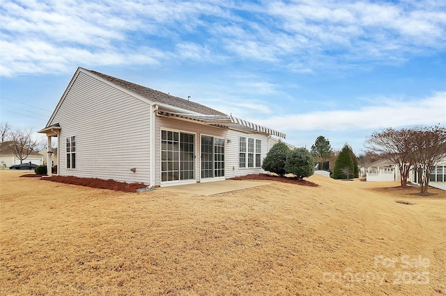 back of house with a patio and a yard