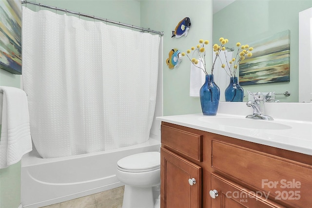 full bathroom with tile patterned flooring, vanity, shower / bath combo with shower curtain, and toilet