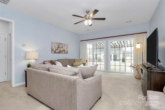 living room with ceiling fan and light colored carpet