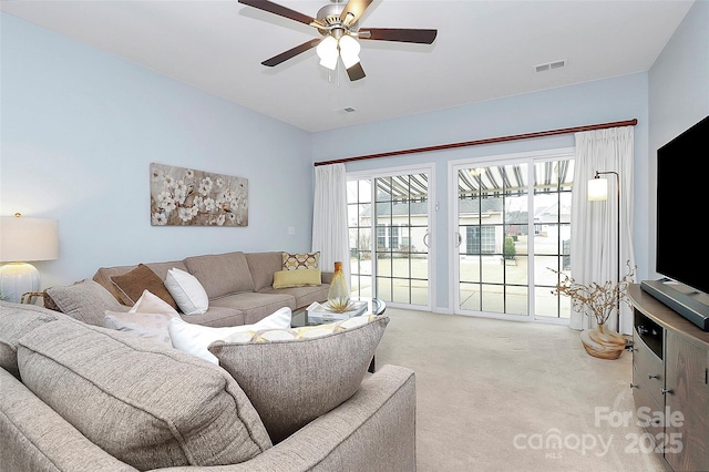 carpeted living room featuring ceiling fan