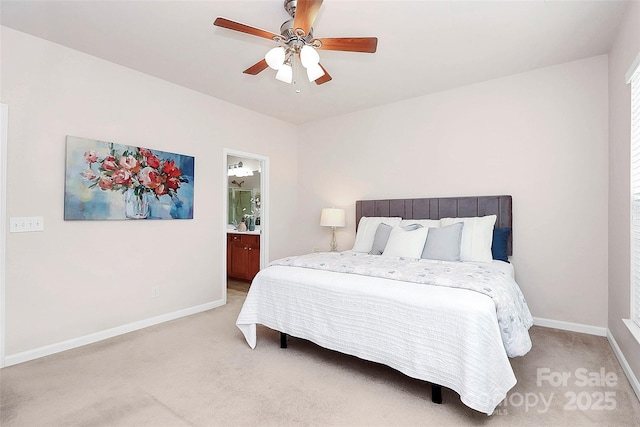 carpeted bedroom with ceiling fan and ensuite bath