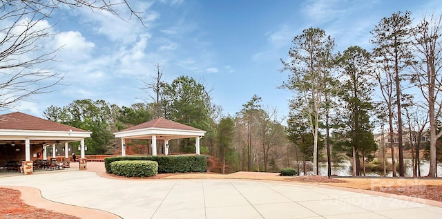 surrounding community featuring a gazebo and a water view