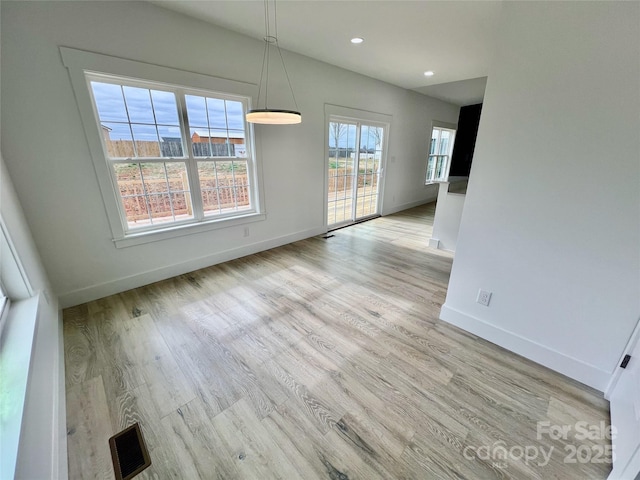 unfurnished dining area with light hardwood / wood-style floors